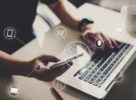 Person working with laptop and phone